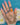 outstretched hand with jewellery laid across the back and white flowers