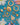 Antique gold jewellery laid out on top of a teal background with white flowers