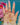 jewellery on a hand in front of a blue background