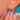 Close detail of the luminous pink cabochon on the ear