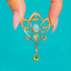 Art Nouveau Gold scroll pendant with central Opal, Pearl edging and green Peridot drop